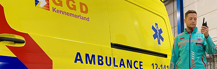 A GGD Kennemerland ambulance worker uses a radio
