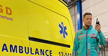 A GGD Kennemerland ambulance worker uses a radio