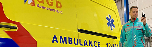 A GGD Kennemerland ambulance worker uses a radio