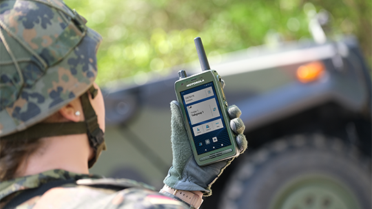 Military personnel using a mobile radio