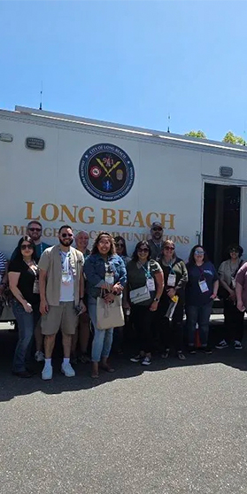 Group of 9-1-1 leaders in front of an emergency vehicle