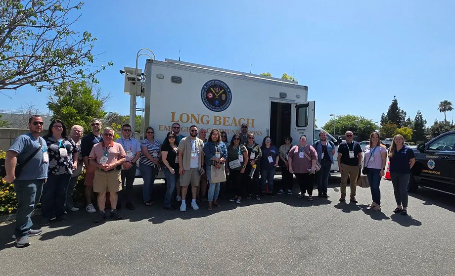 Group of 9-1-1 leaders in front of an emergency vehicle