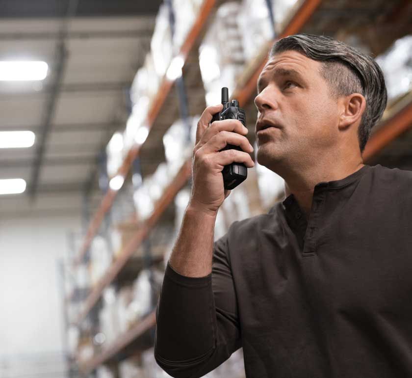 Man talking into a radio in a distribution center