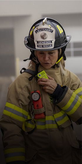 Firefighter with Motorola Solutions remote speaker mic