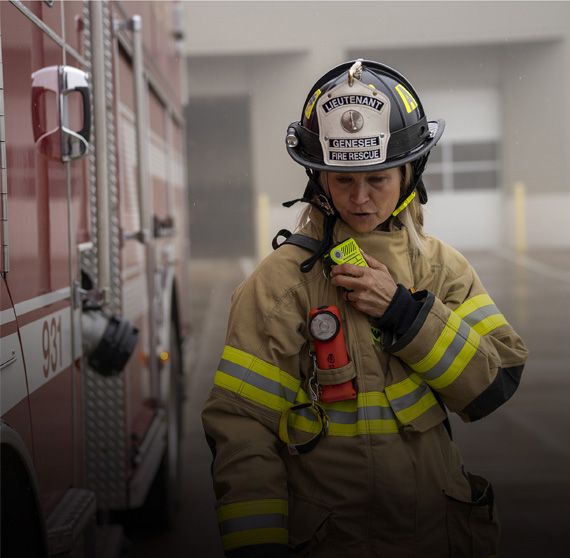 Firefighter with Motorola Solutions remote speaker mic