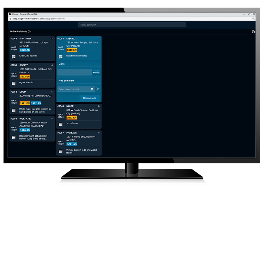 A screen capture of the "CommandCentral CAD" interface on a monitor. The screen lists seven active incidents including categories like "MVA - INJY," "DISORD," "ASSIST," and "WELFARE." Each card displays the incident type, a specific address in locations like Salt Lake City or Layton, assigned unit IDs, and brief status notes.