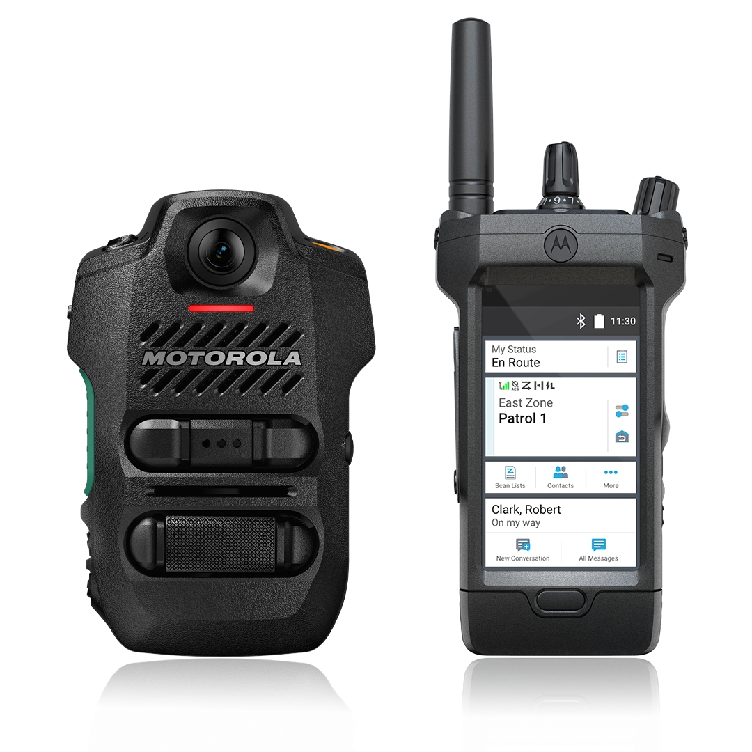 Front view of Motorola’s AI-integrated public safety hardware, featuring a rugged V700 body camera and an APX NEXT smart radio. The radio's interface demonstrates smart applications like location tracking and a voice-activated virtual assistant (ViQi) for hands-free database queries.