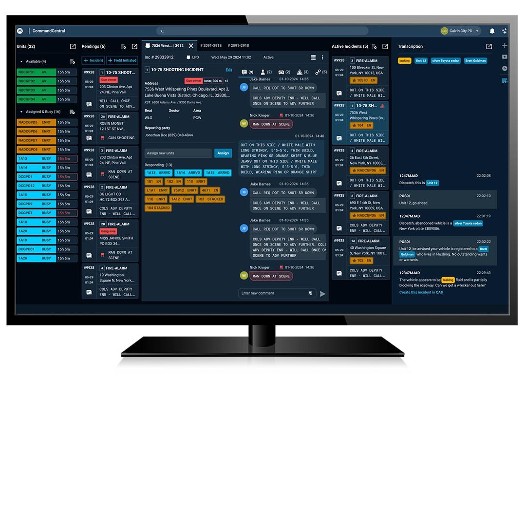 A monitor displaying a complex emergency dispatch dashboard. The screen lists "Available," "Assigned," and "Pending" units on the left. The center panel details the location of a "Shooting Incident" with live transcript bubbles from responders. 