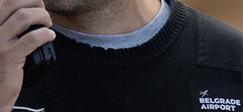 A Belgrade airport employee uses a radio