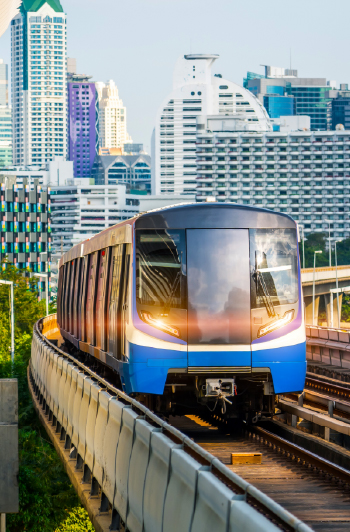 Train on a rail track with skyscrapers in background
