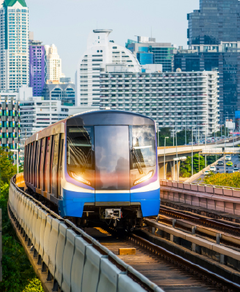 Train on a rail track with skyscrapers in background