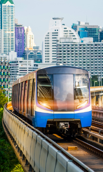 Train on a rail track with skyscrapers in background