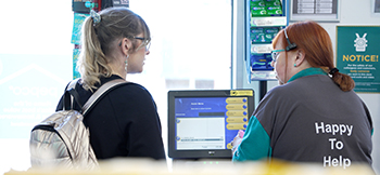 Shop keeper helping customer