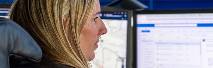 Woman looking at multiple monitors