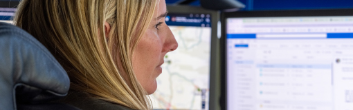 Woman looking at multiple monitors