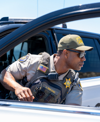 Police officer getting out of police car