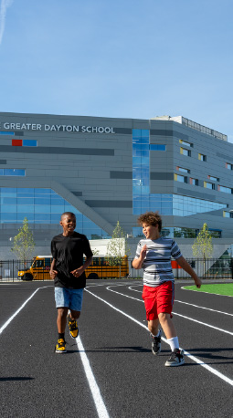 Students run on a track at Greater Dayton School