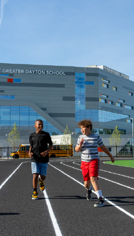 Students run on a track at Greater Dayton School