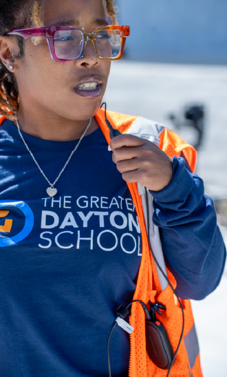 A member of staff at Greater Dayton School uses a Motorola Solutions radio