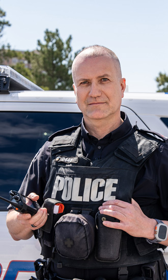 Peel Regional Police officer in front of police car