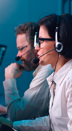 Operators wearing headsets in a command center.