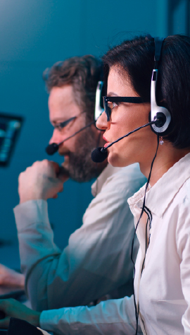 Operators wearing headsets in a command center.
