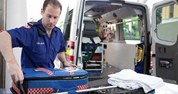 Paramedic working out of back of ambulance