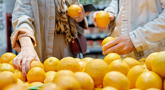 Shoppers select oranges in a supermarket 