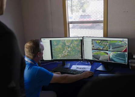 Personnel looking at computer screen of video footage