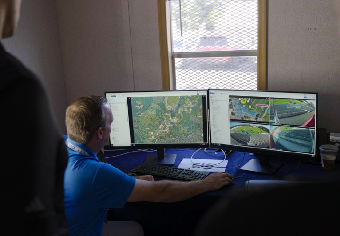 Personnel looking at computer screen of video footage