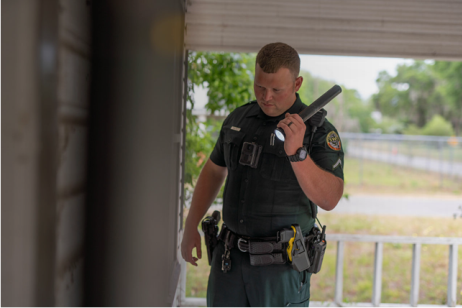 Image of an officer approaching an abandoned building
