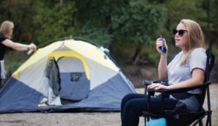 Woman camping with blue t270 in hand