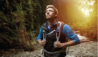 Man hiking with blue t380 on backpack