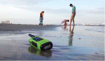 Green waterproof walkie talkie on beach