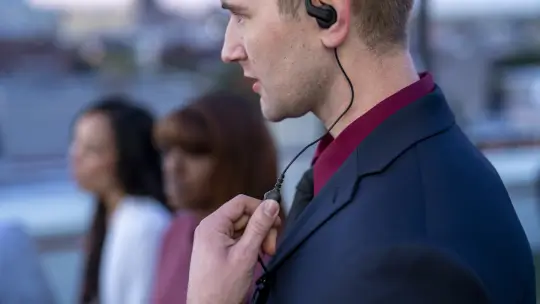 A person speaking into the microphone of their headset.
