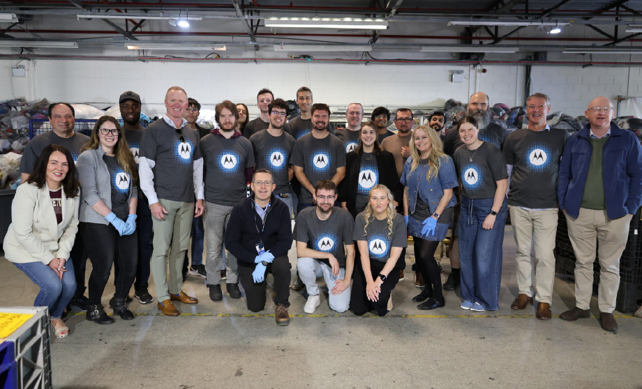 A group of people standing together wearing Motorola Solutions shirts.