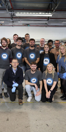 A group of people standing together wearing Motorola Solutions shirts.