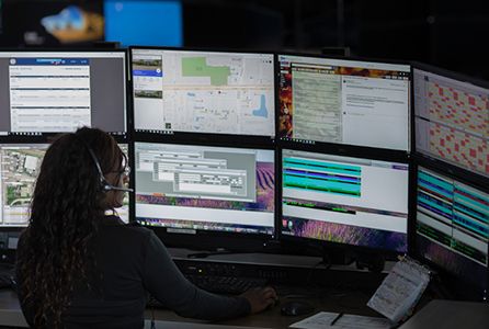 Dispatcher utilizing police cad software at desk