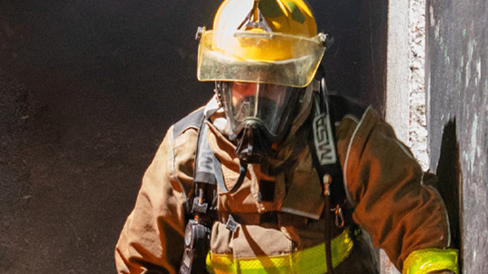 A man and a woman looking at a laptop