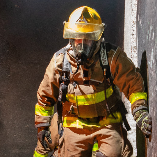 A man and a woman looking at a laptop