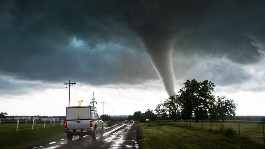 Image of a tornado about to cross a rural road
