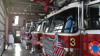 Image of a firefighter exiting a firetruck