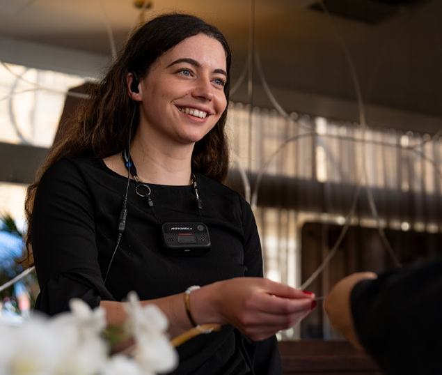 Hotel worker with body camera on smiling at guest