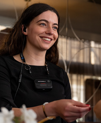 Hotel worker with body camera on smiling at guest
