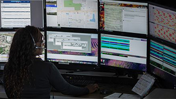 women looking at systems in control room