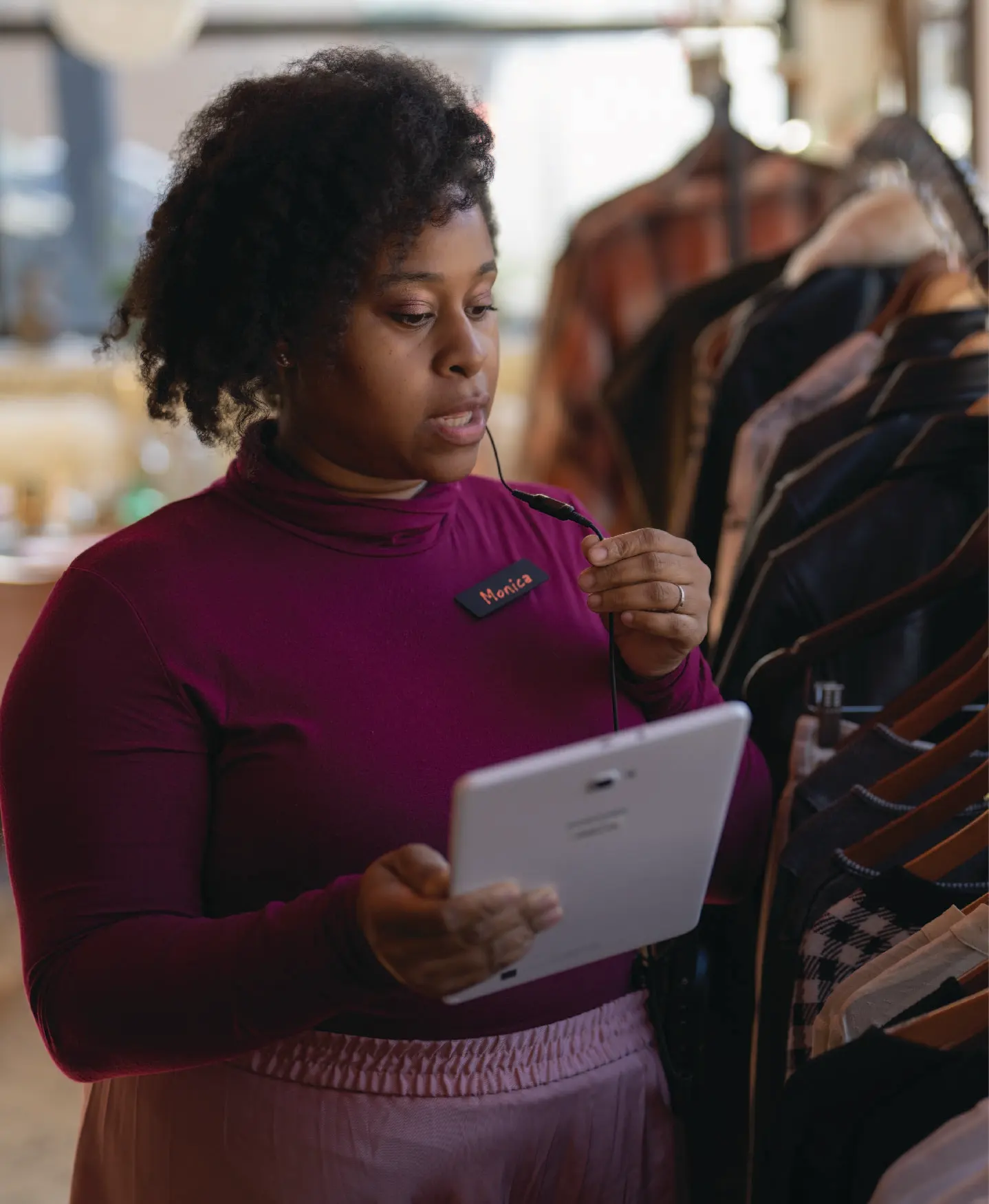 Retail worker using tablet in store