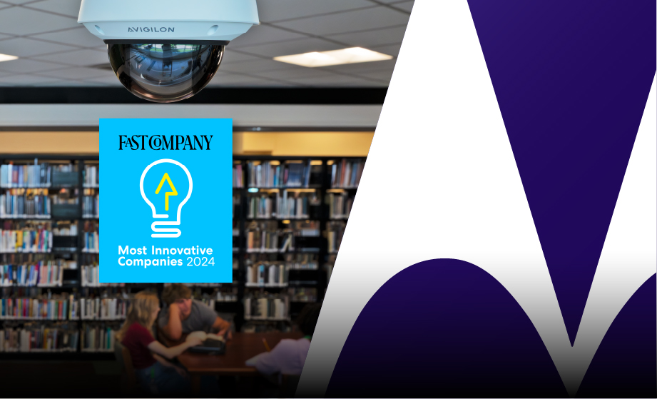 Image of Fast Company Logo and Avigilon ceiling camera in library with students