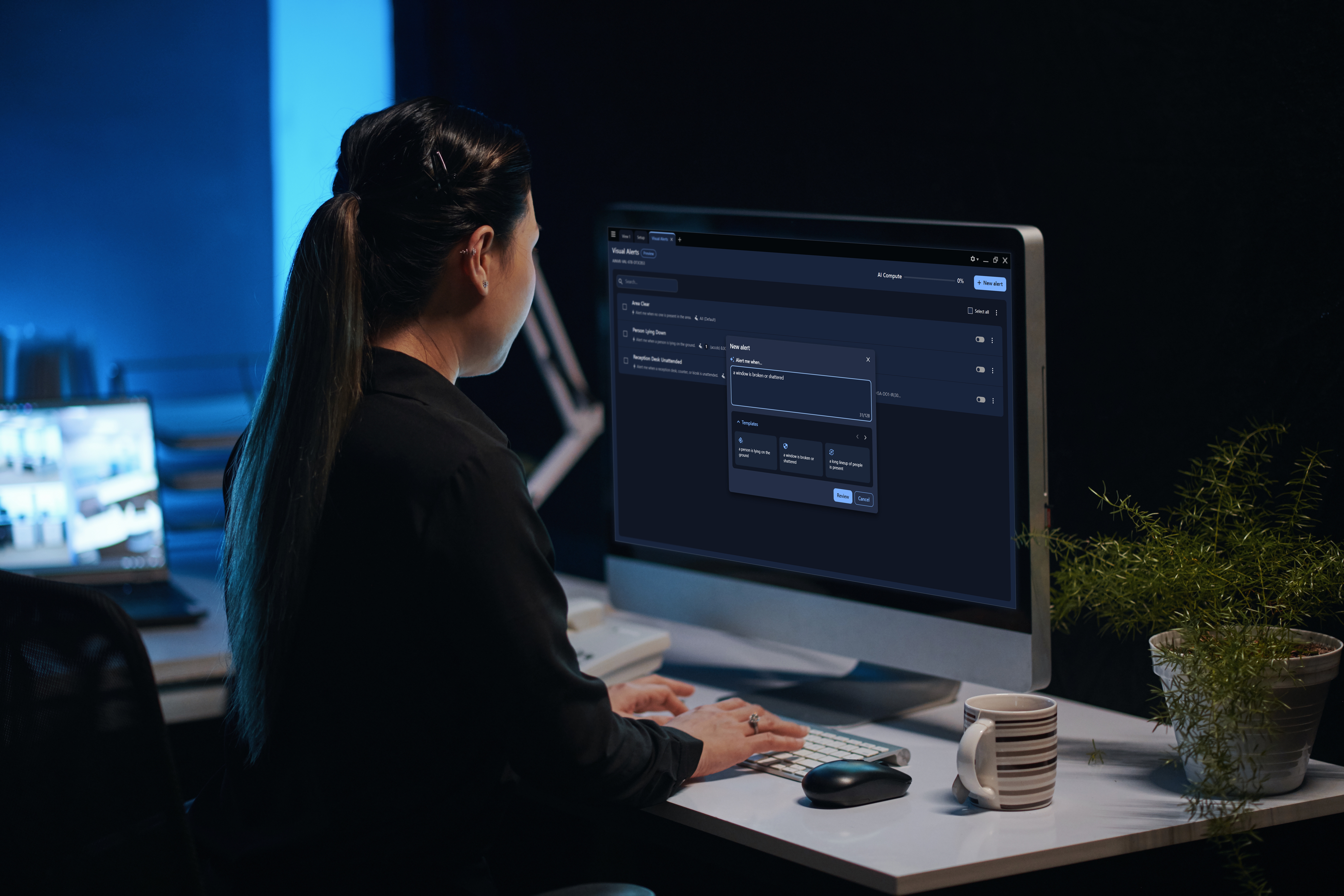 Woman working on a computer in a security room