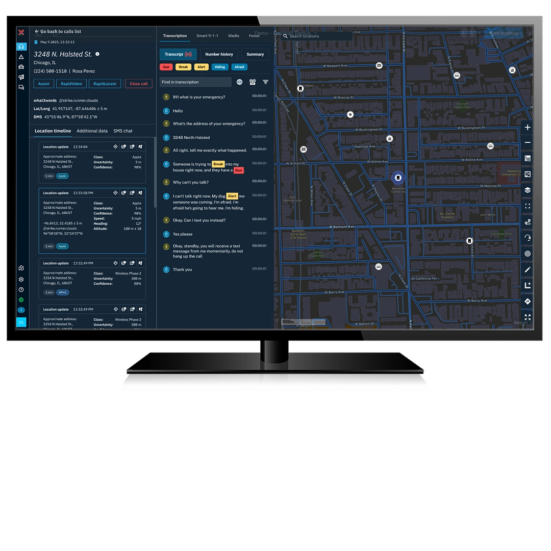 A monitor displays a call-taking interface showing a live emergency call. The left panel displays call details for the location and a live transcript of the call. The right panel shows a dark-mode street map with icons indicating location of the caller and nearby units.