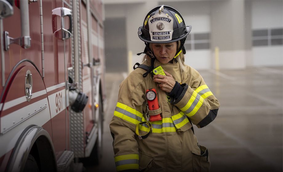 Firefighter with Motorola Solutions remote speaker mic